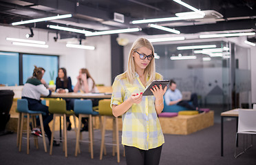 Image showing blonde businesswoman working online using digital tablet