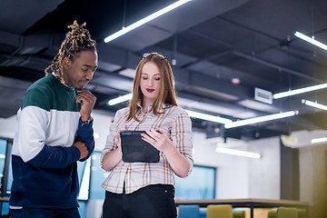 Image showing multiethnic business couple using a tablet computer