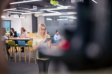 Image showing blonde businesswoman working online using digital tablet