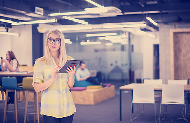 Image showing blonde businesswoman working online using digital tablet