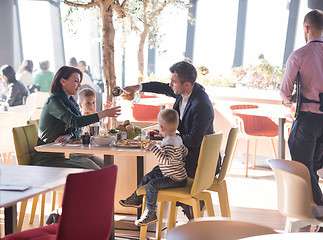 Image showing Young parents enjoying lunch time with their children