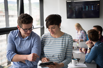 Image showing Two Business People Working With Tablet in office