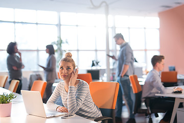 Image showing businesswoman using a laptop in startup office