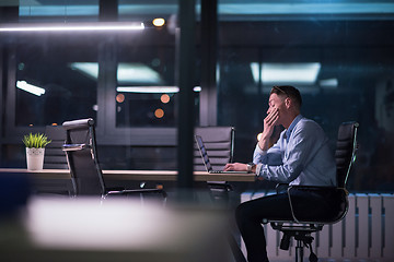 Image showing man working on laptop in dark office