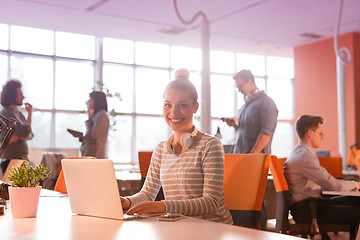 Image showing businesswoman using a laptop in startup office