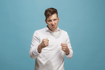 Image showing The young emotional angry man screaming on studio background