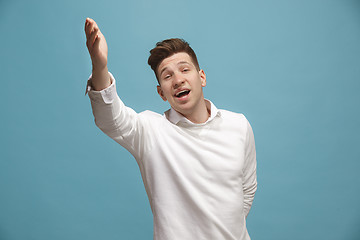 Image showing Beautiful male half-length portrait isolated on studio backgroud. The young emotional surprised man