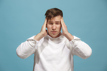 Image showing Man having headache. Isolated over background.