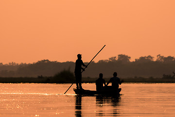 Image showing Men in a boat on a river silhouette