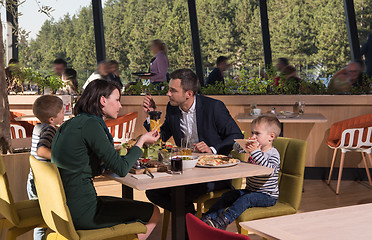 Image showing Young parents enjoying lunch time with their children
