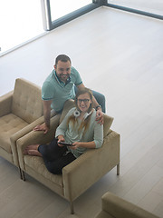 Image showing couple relaxing at  home with tablet computers