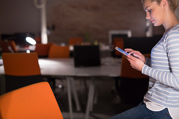 Image showing woman working on digital tablet in night office