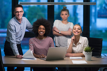 Image showing Multiethnic startup business team in night office