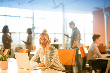 Image showing businesswoman using a laptop in startup office