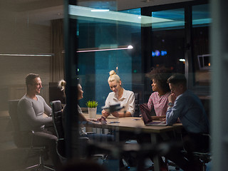 Image showing Multiethnic startup business team in night office