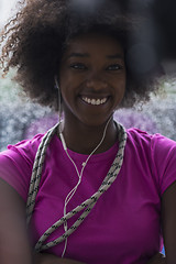 Image showing portrait of young afro american woman in gym while listening mus