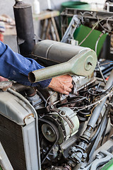 Image showing Man repairing old dirty car engine