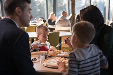 Image showing Young parents enjoying lunch time with their children