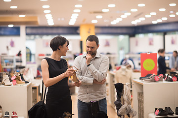 Image showing couple chooses shoes At Shoe Store