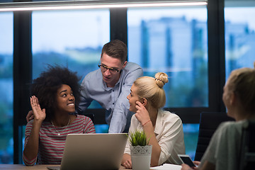 Image showing Multiethnic startup business team in night office