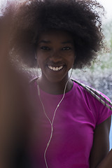 Image showing portrait of young afro american woman in gym while listening mus