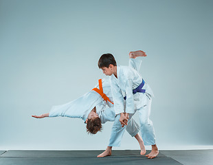 Image showing The two boys fighting at Aikido training in martial arts school. Healthy lifestyle and sports concept