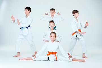 Image showing The group of boys and girl fighting at Aikido training in martial arts school. Healthy lifestyle and sports concept