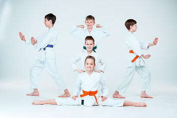 Image showing The group of boys and girl fighting at Aikido training in martial arts school. Healthy lifestyle and sports concept