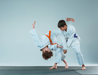 Image showing The two boys fighting at Aikido training in martial arts school. Healthy lifestyle and sports concept