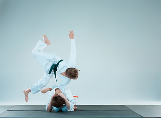 Image showing The two boys fighting at Aikido training in martial arts school. Healthy lifestyle and sports concept