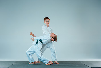 Image showing The two boys fighting at Aikido training in martial arts school. Healthy lifestyle and sports concept