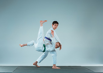 Image showing The two boys fighting at Aikido training in martial arts school. Healthy lifestyle and sports concept