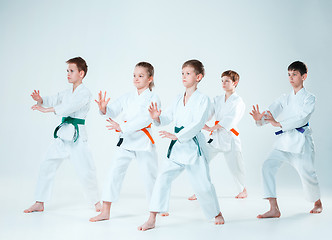 Image showing The group of boys and girl fighting at Aikido training in martial arts school. Healthy lifestyle and sports concept