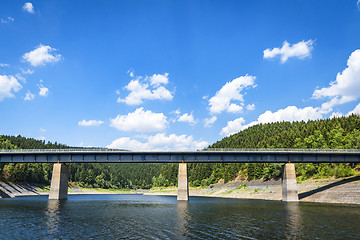 Image showing Large bridge over a lake near a forest