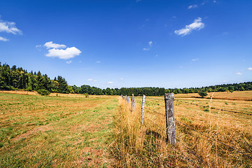Image showing Rural scenery with a fence on dry land in the summer