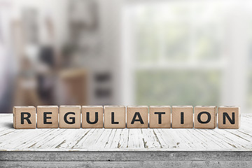 Image showing Regulation sign on a wooden table