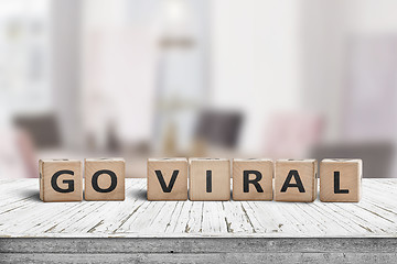 Image showing Go viral message sign on a wooden table