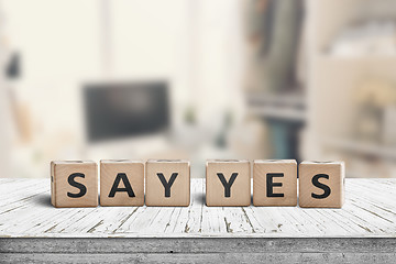 Image showing Say yes sign on a wooden desk in a bright room