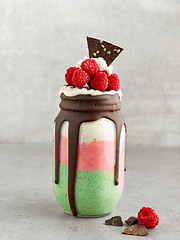 Image showing dessert of frozen banana with matcha and raspberries