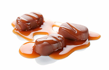 Image showing chocolate candies with caramel sauce