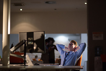 Image showing businessman relaxing at the desk