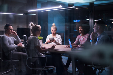 Image showing Multiethnic startup business team in night office