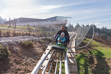 Image showing father and son enjoys driving on alpine coaster