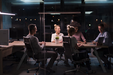 Image showing Multiethnic startup business team in night office