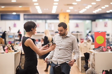 Image showing couple chooses shoes At Shoe Store