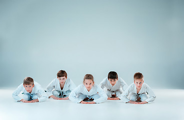 Image showing The group of boys and girl fighting at Aikido training in martial arts school. Healthy lifestyle and sports concept