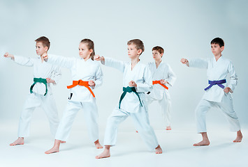 Image showing The group of boys and girl fighting at Aikido training in martial arts school. Healthy lifestyle and sports concept