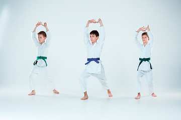 Image showing The group of boys fighting at Aikido training in martial arts school. Healthy lifestyle and sports concept