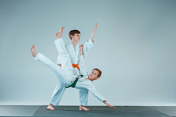 Image showing The two boys fighting at Aikido training in martial arts school. Healthy lifestyle and sports concept