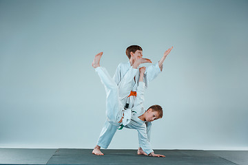 Image showing The two boys fighting at Aikido training in martial arts school. Healthy lifestyle and sports concept